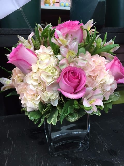 Stunning Pink Bouquet in Cube Vase - This STUNNING pink bouquet is a favorite among the staff here at Mr Bokay. Our customers show similar gratitude to this wonderful bouquet. A best seller, this bouquet always comes through and makes both customer and recipient happy. Hand-crafted and designed with love, warmth, pink hydrangea, pink roses, and greenery in a cube vase. Great for every occasion, great for parties, and it's even been a wedding centerpiece on more than one occasion!
