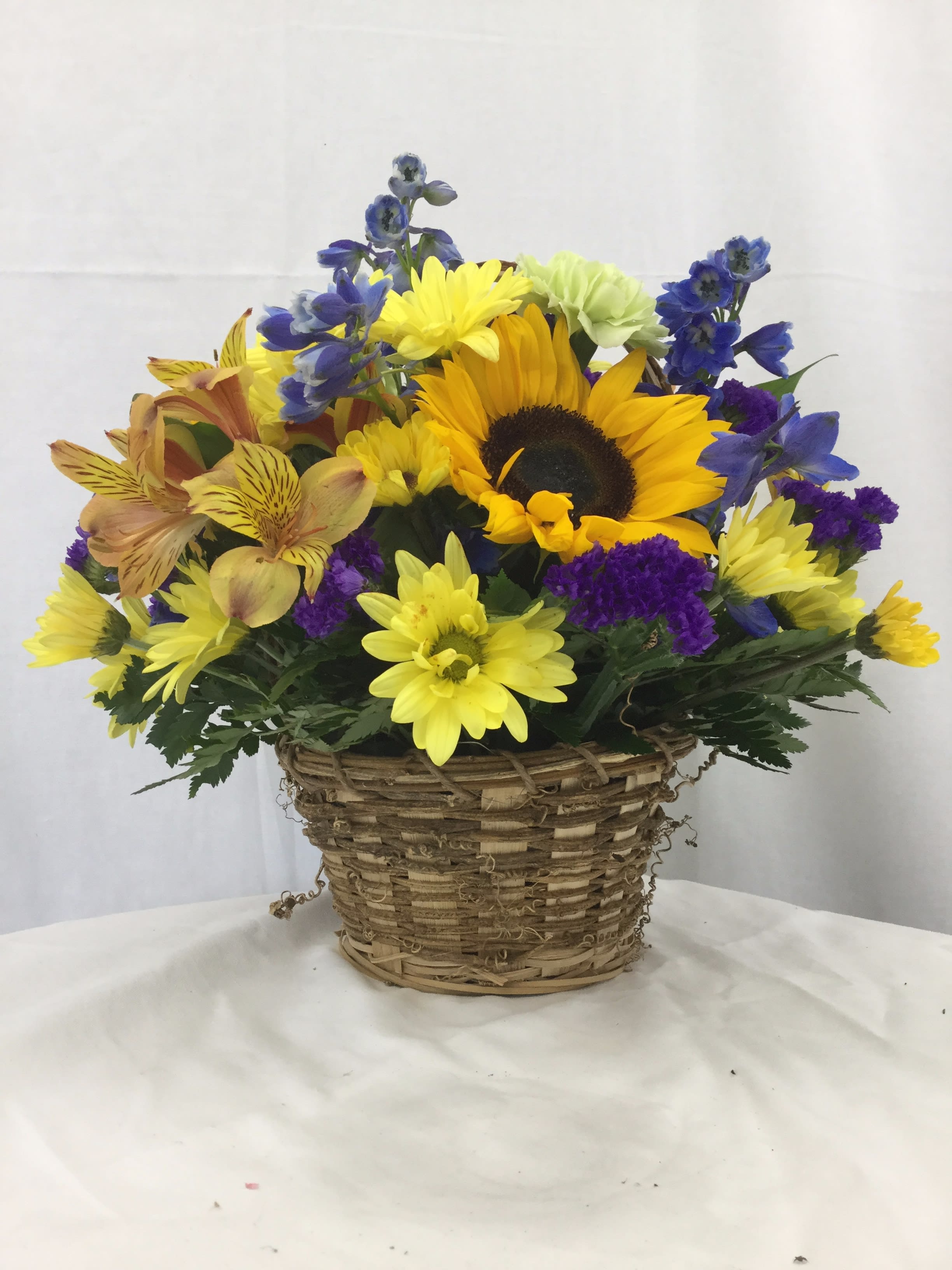 Basket of Beauty - A beautiful wicker basket full of fresh Autumn themed blooms. Makes for a wonderful gift throughout the Autumn and Winter months.