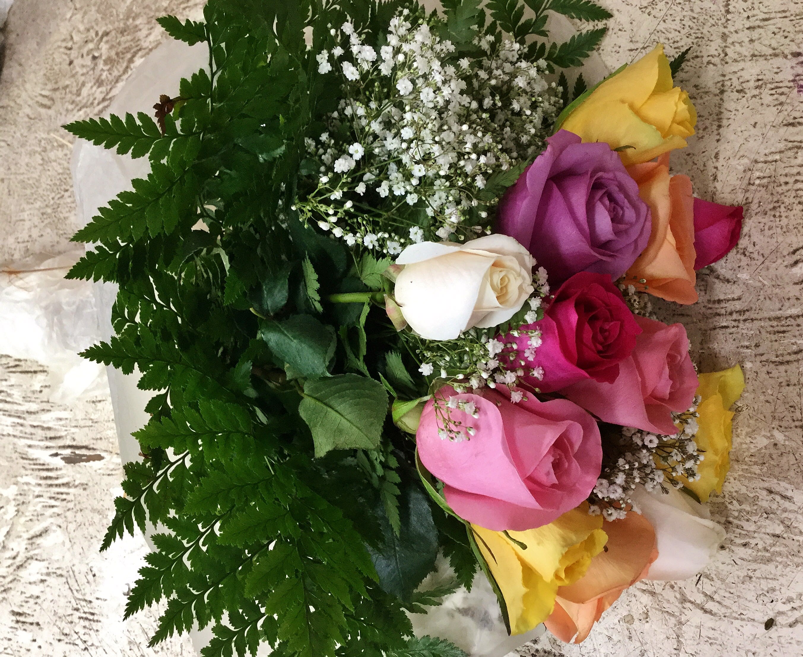 Bouquet of multicolored roses with white baby's breath