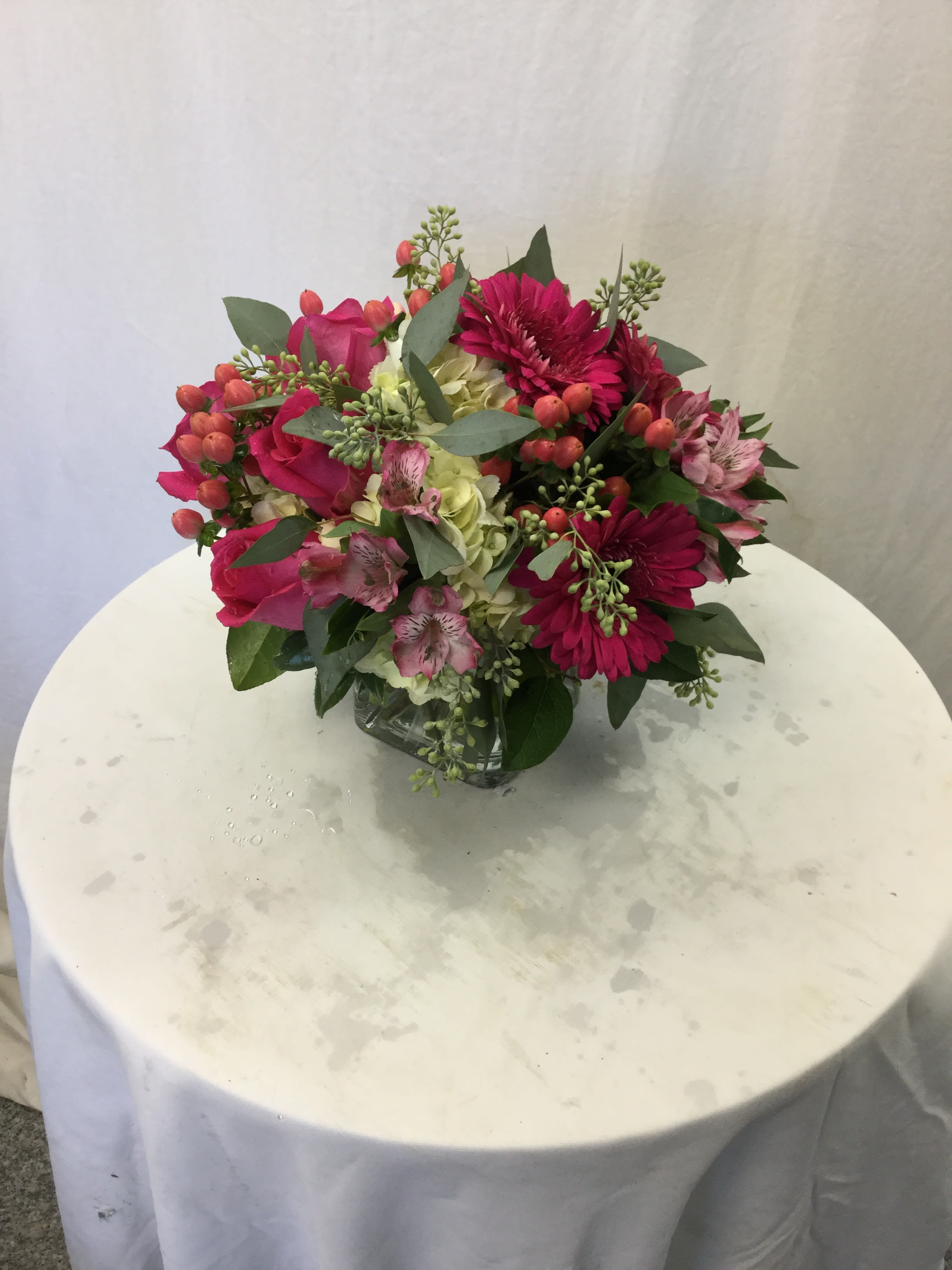 Pink and magenta mixed bouquet in a clear glass vase