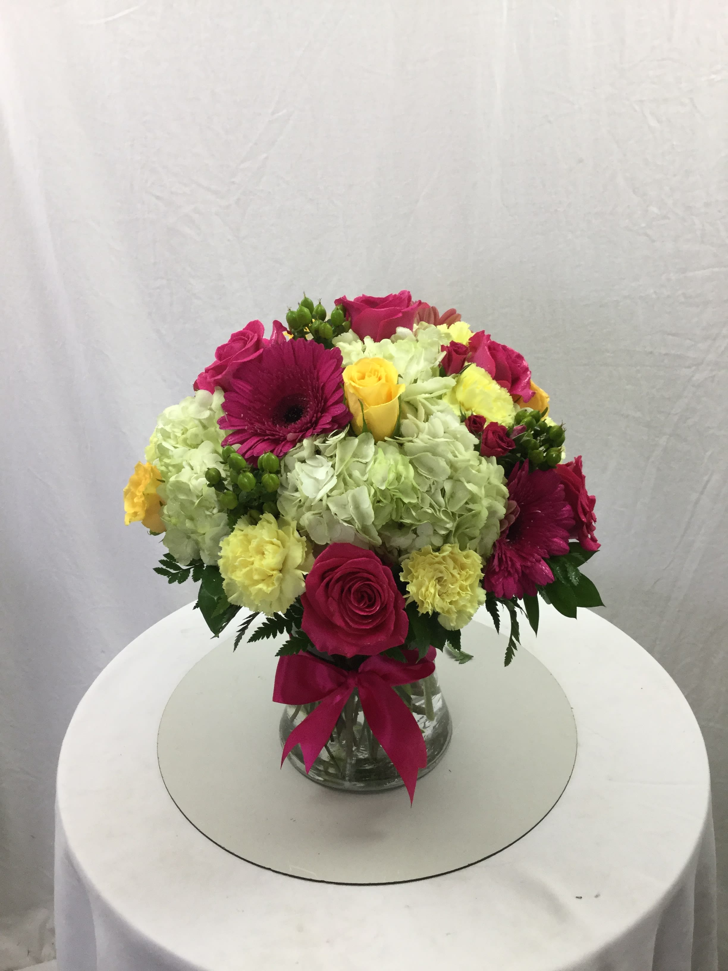 Love and Laughter Bouquet - This beautiful bouquet makes for a wonderful gift for every special occasion. Full of fresh bold blooms, fresh greens, a clear glass vase and topped off with a beautiful bow.