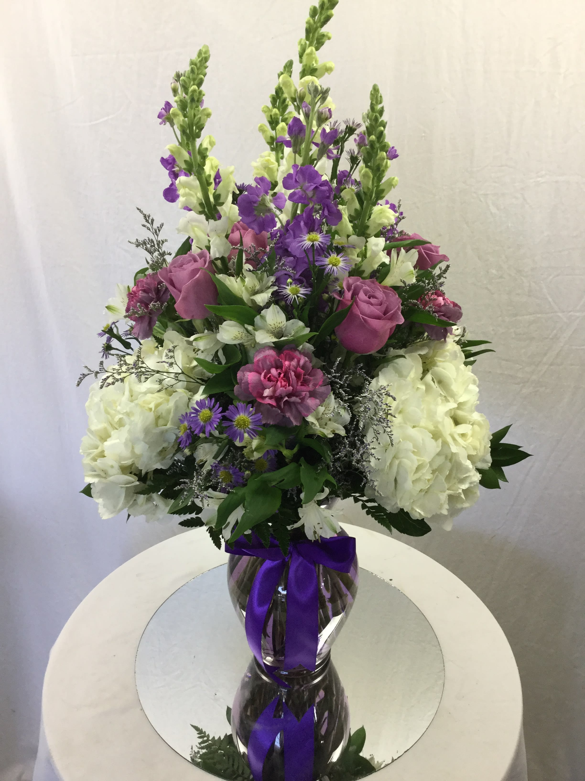 Purple Affection Bouquet - This stunning bouquet makes for a wonderful gift for every special occasion. Handcrafted and designed with love in mind, full of fresh blooms, greens and a purple glass vase.