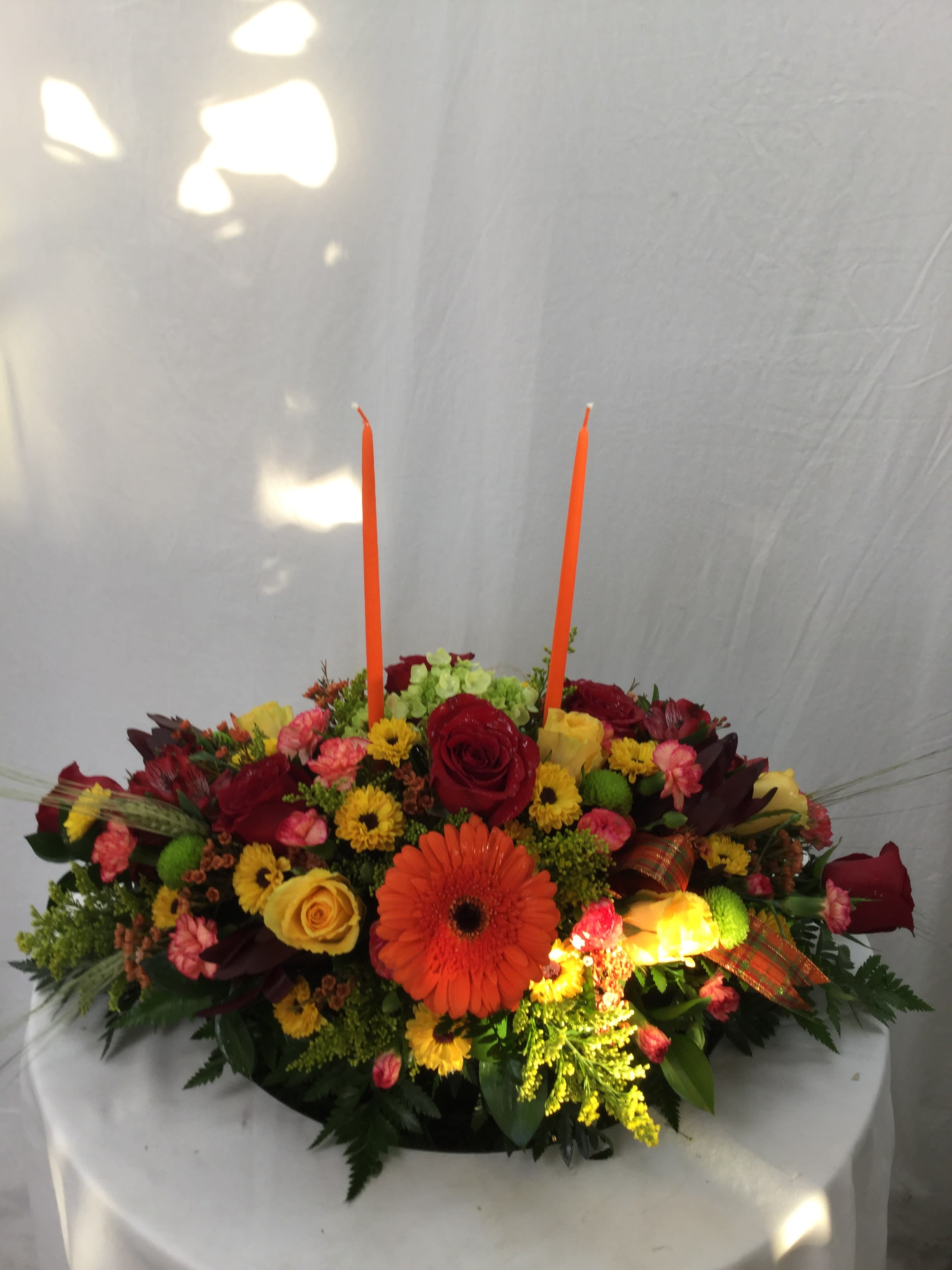 Thanksgiving Dinner Centerpiece - This stunning mix of fresh Autumn blooms, greenery and two candles makes for the perfect gift for Thanksgiving Dinner.