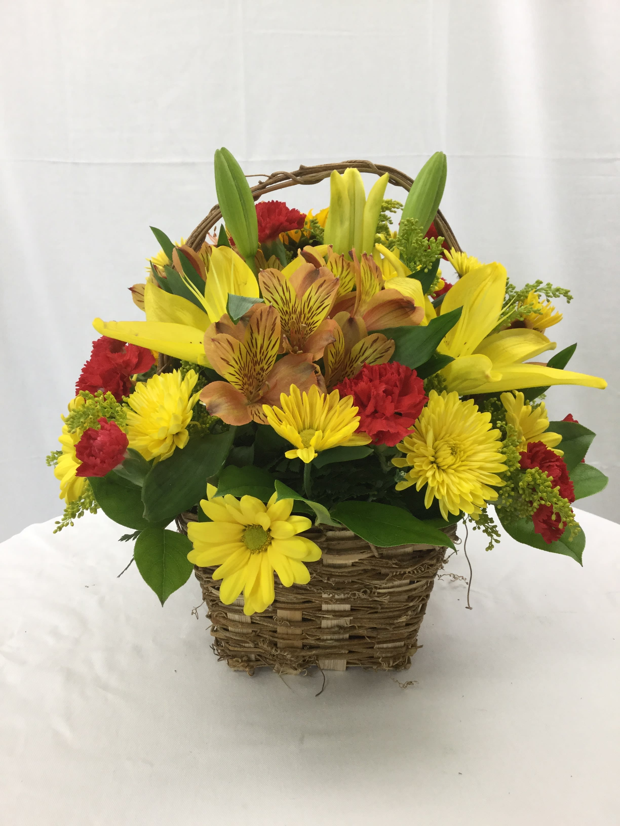 Autumn Basket - This stunning basket arrangement makes for a wonderful gift during the Autumn Season. Full of fresh blooms and hand-crafted and designed with fresh greens in a beautiful brown basket. Baskets may vary, but they will be brown.