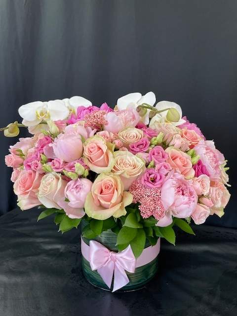 Elegance of Love Bouquet - This stunning bouquet is full of fresh blooms and greenery. Hand-crafted and designed in a clear glass vase, leaf-wrapped, and topped off with a beautiful bow. Makes for the perfect gift for every special occasion!