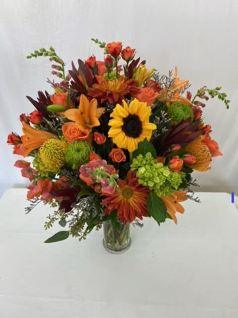 Autumn Beauty Bouquet - This stunning bouquet makes for the most perfect gift. This hand-crafted bouquet is made with fresh Autumn blooms and greenery, includes a clear glass vase.