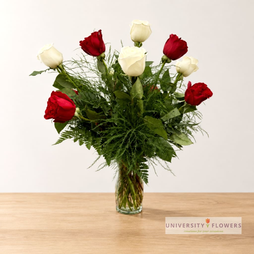 Red and white roses in a clear glass vase