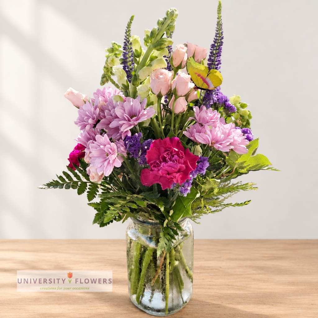 Mixed pink and purple bouquet in a clear glass vase