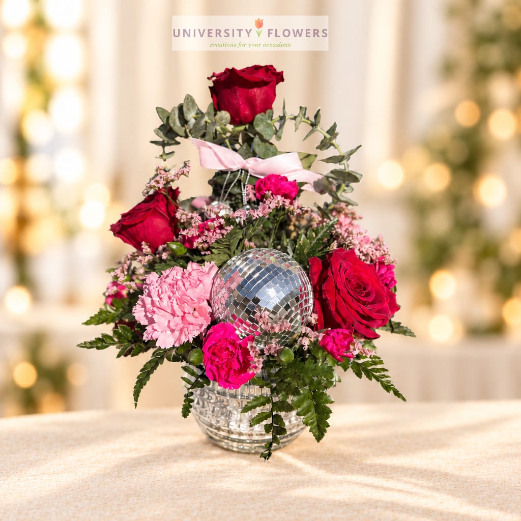 Pink and red roses with carnations in a glass vase and disco ball