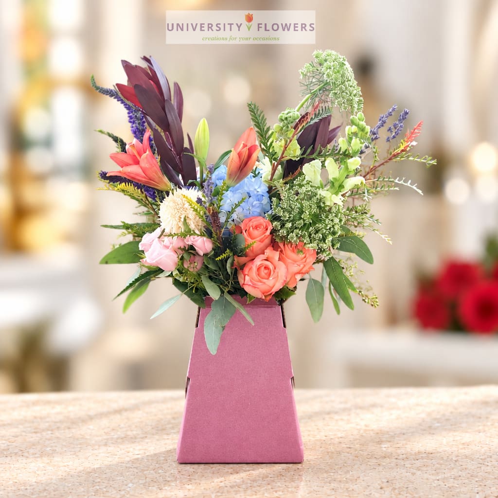 Colorful mixed bouquet in a pink gift box