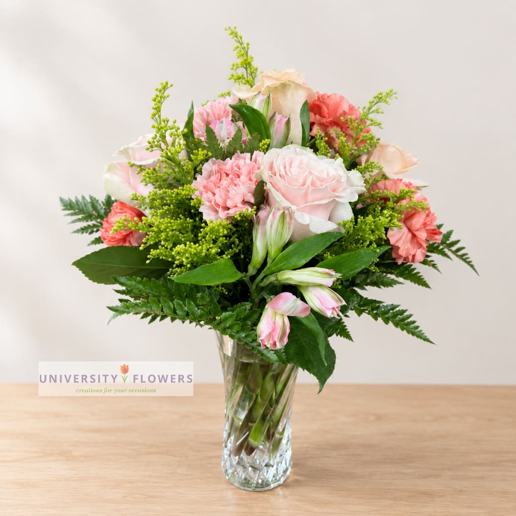 Pink and peach mixed bouquet in a clear glass vase