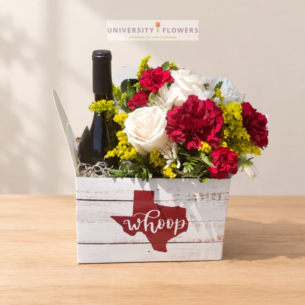 Flower arrangement in a white box with a wine bottle and red Texas graphic
