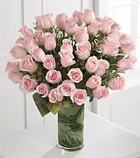 Pink roses arranged in a clear glass vase