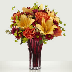Many Thanks™ Bouquet - An exuberance of warm, sun drenched color seems to burst forth in a cloud of pure beauty. This refined mixed-flower bouquet is a showstopper with orange roses, daisy poms, peach Asiatic lilies, bupleurem and seeded eucalyptus arranged in a vase. You can count on this high-fashion bouquet to make any fall occasion truly special.