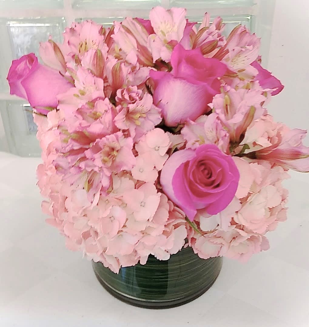 Pink roses and alstroemeria arranged in a glass vase
