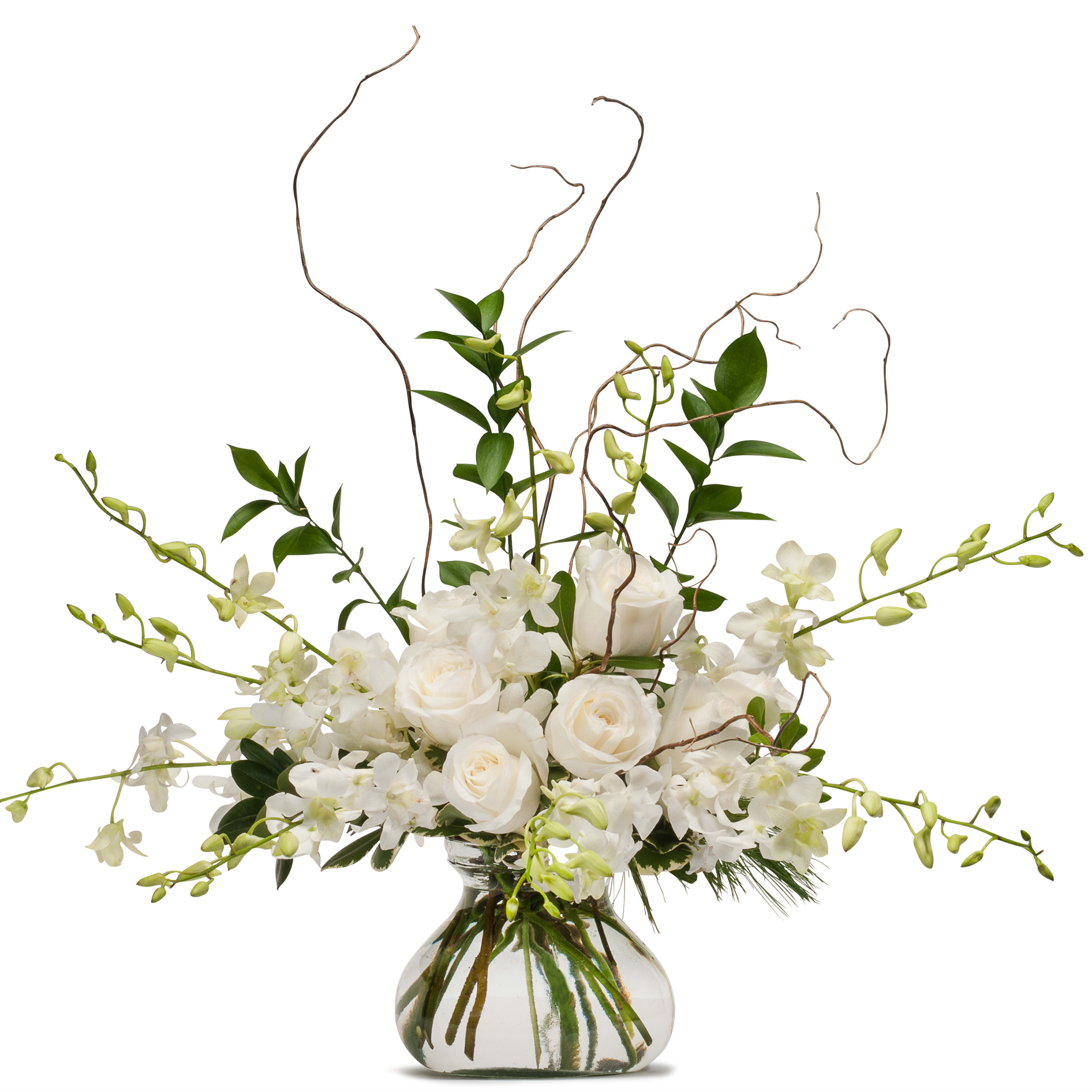 White roses and orchids in a clear glass vase with curly branches