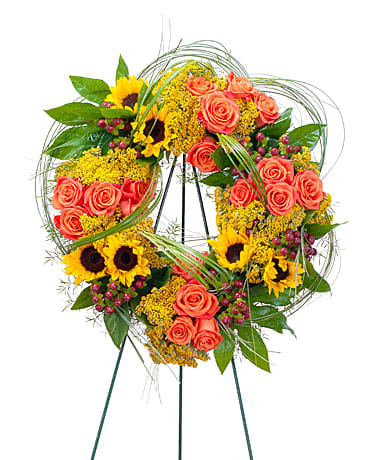 Heaven's Sunset Wreath - The colors of sunset are evident in this beautiful wreath including sunflowers and roses with accents of other premium flowers and foliage. 