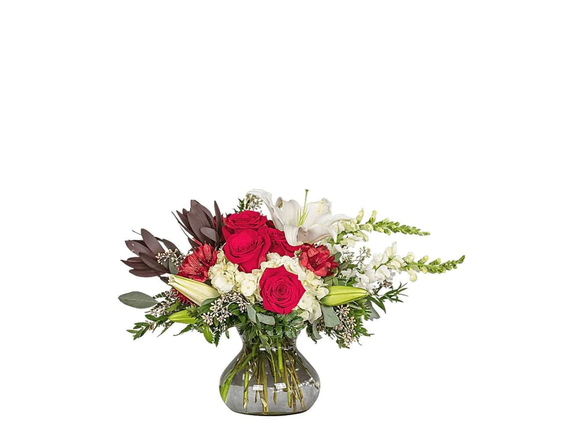 Bouquet of red roses and white lilies in a glass vase