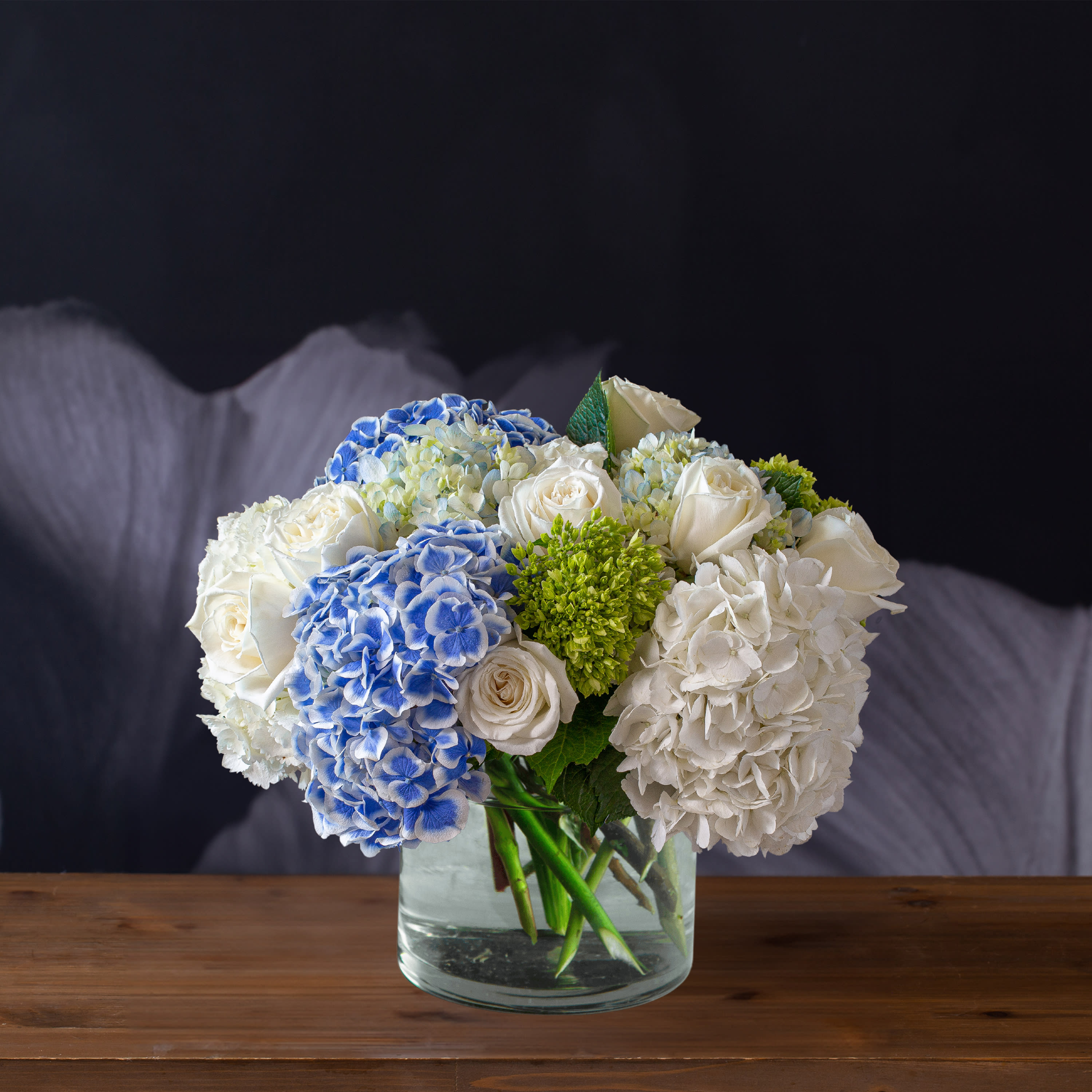 Together in Perfect Harmony - Together in Perfect Harmony is a calming blend of blues, whites and greens. This mix of hydrangeas and roses are perfect for bringing peace to lifes crazy moments.