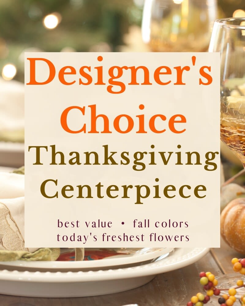 Thanksgiving centerpiece sign on a table with glassware and pumpkins