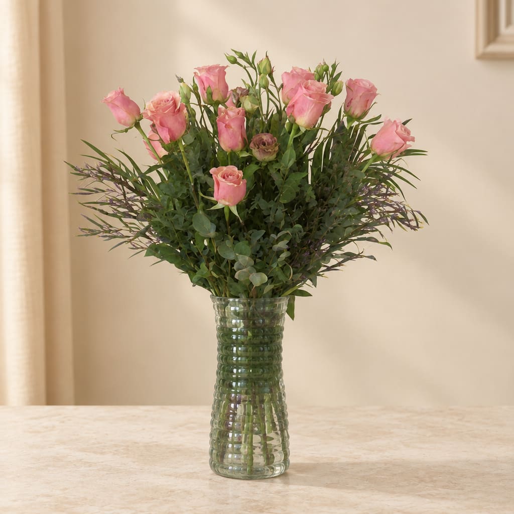 Pink roses arranged in a clear glass vase