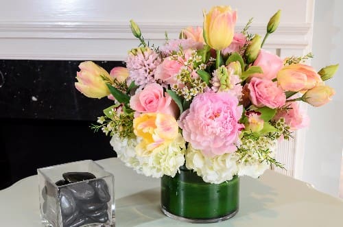 Pink and peach tulips with roses in a green vase