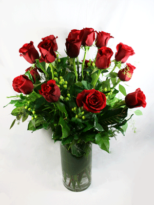 Red roses arranged in a clear glass vase