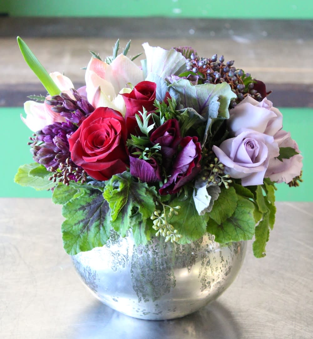 Mixed bouquet of roses and lilies in a silver vase