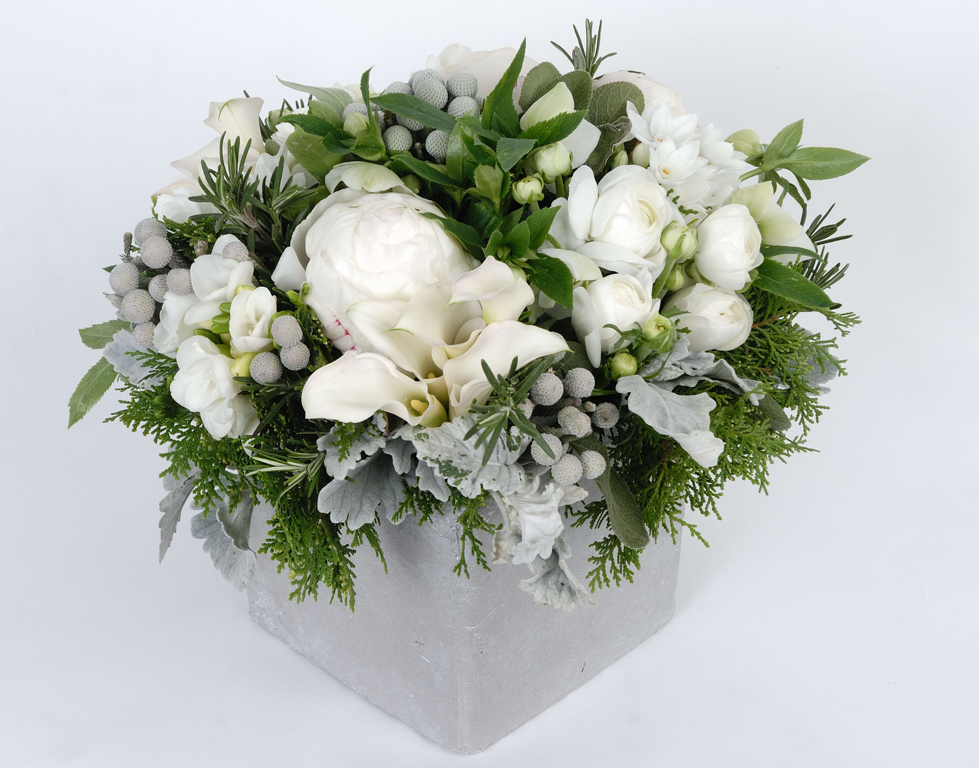 White floral arrangement in a silver box with greenery