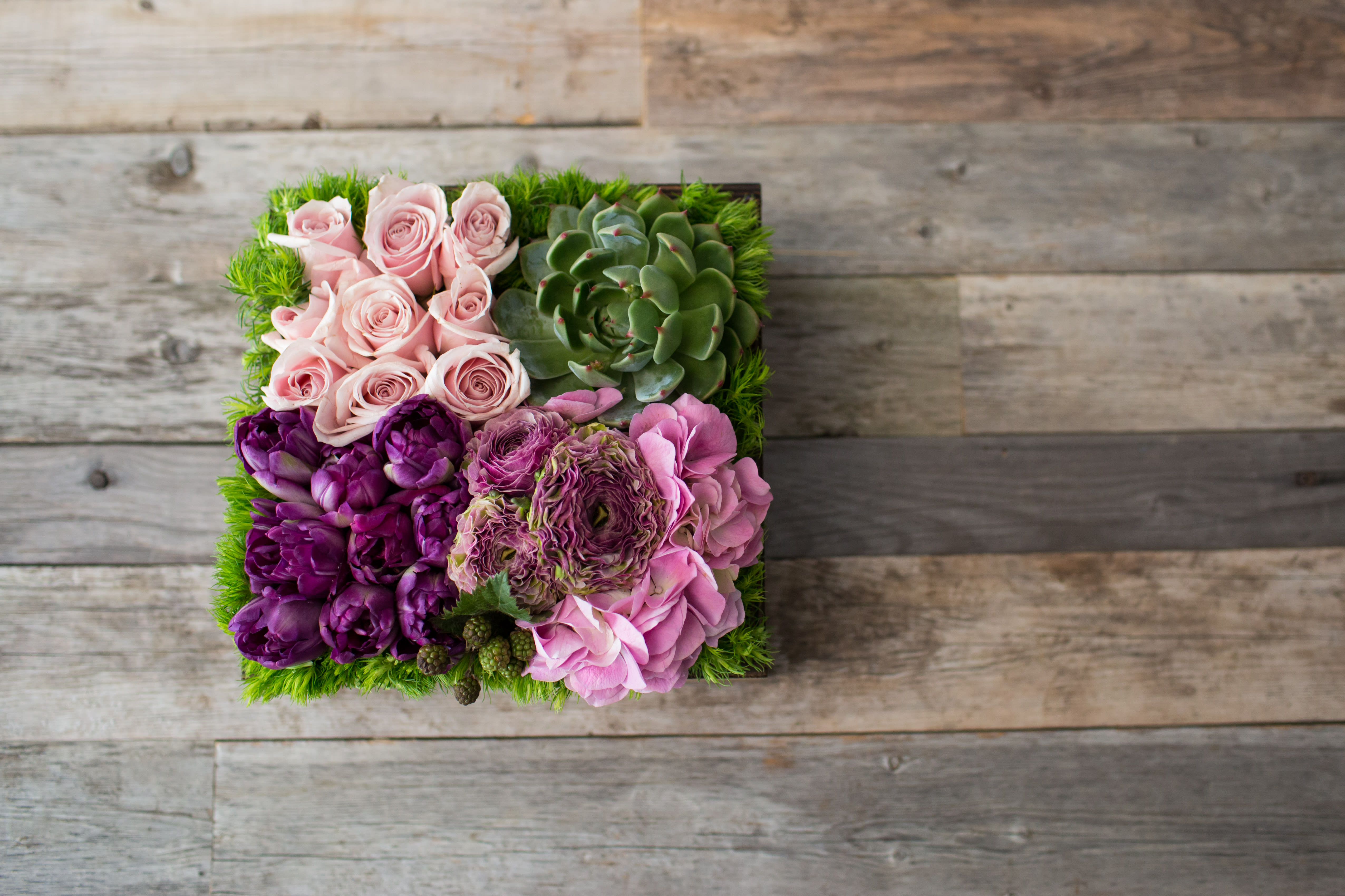 Square succulent and rose arrangement in pink and purple tones
