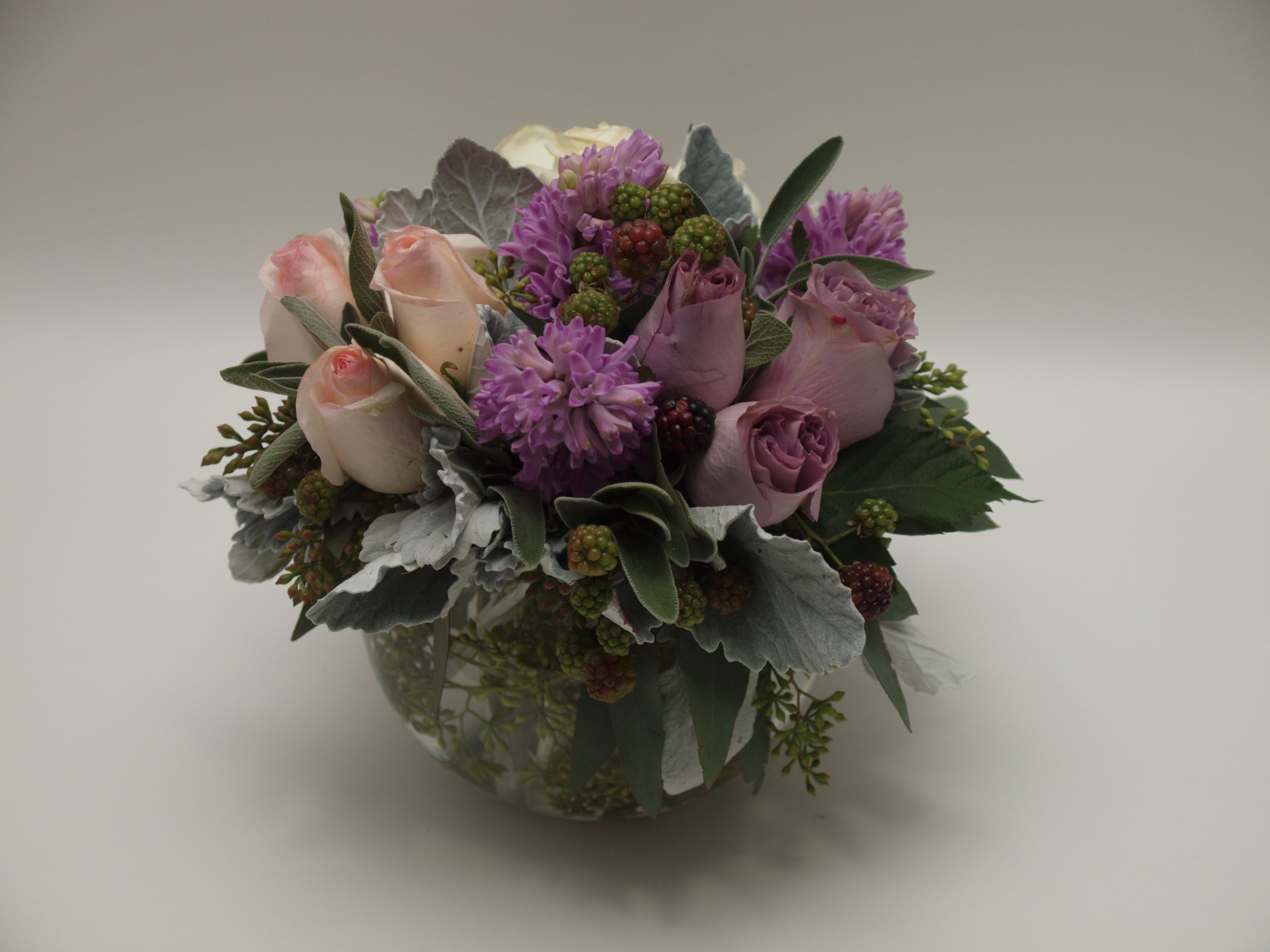 Bouquet of pink and lavender roses in a glass vase
