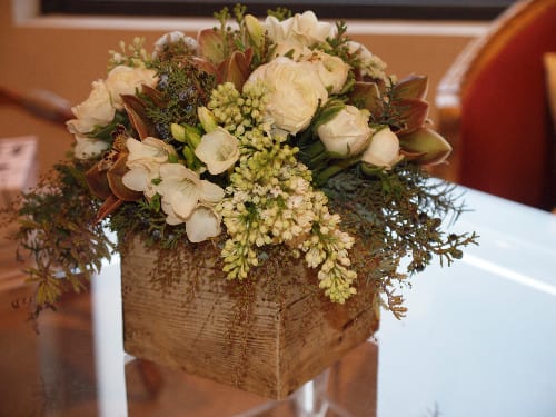 White floral arrangement in a rustic wooden box
