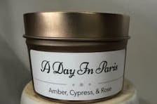 Scented candle in a metal tin with a white label