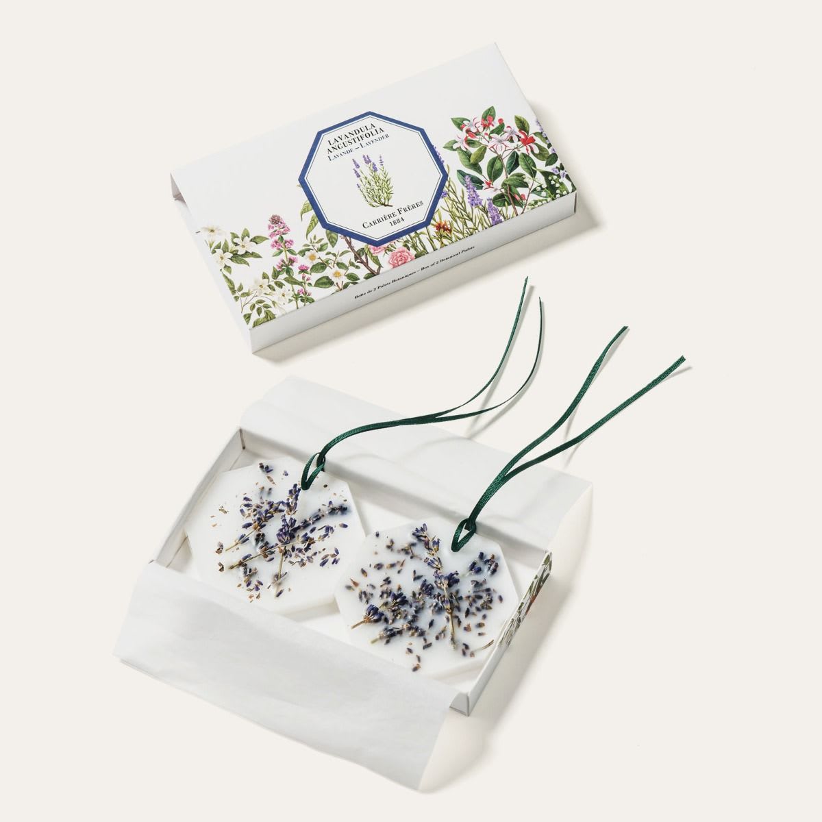 Two floral wax sachets in a gift box with lavender sprigs