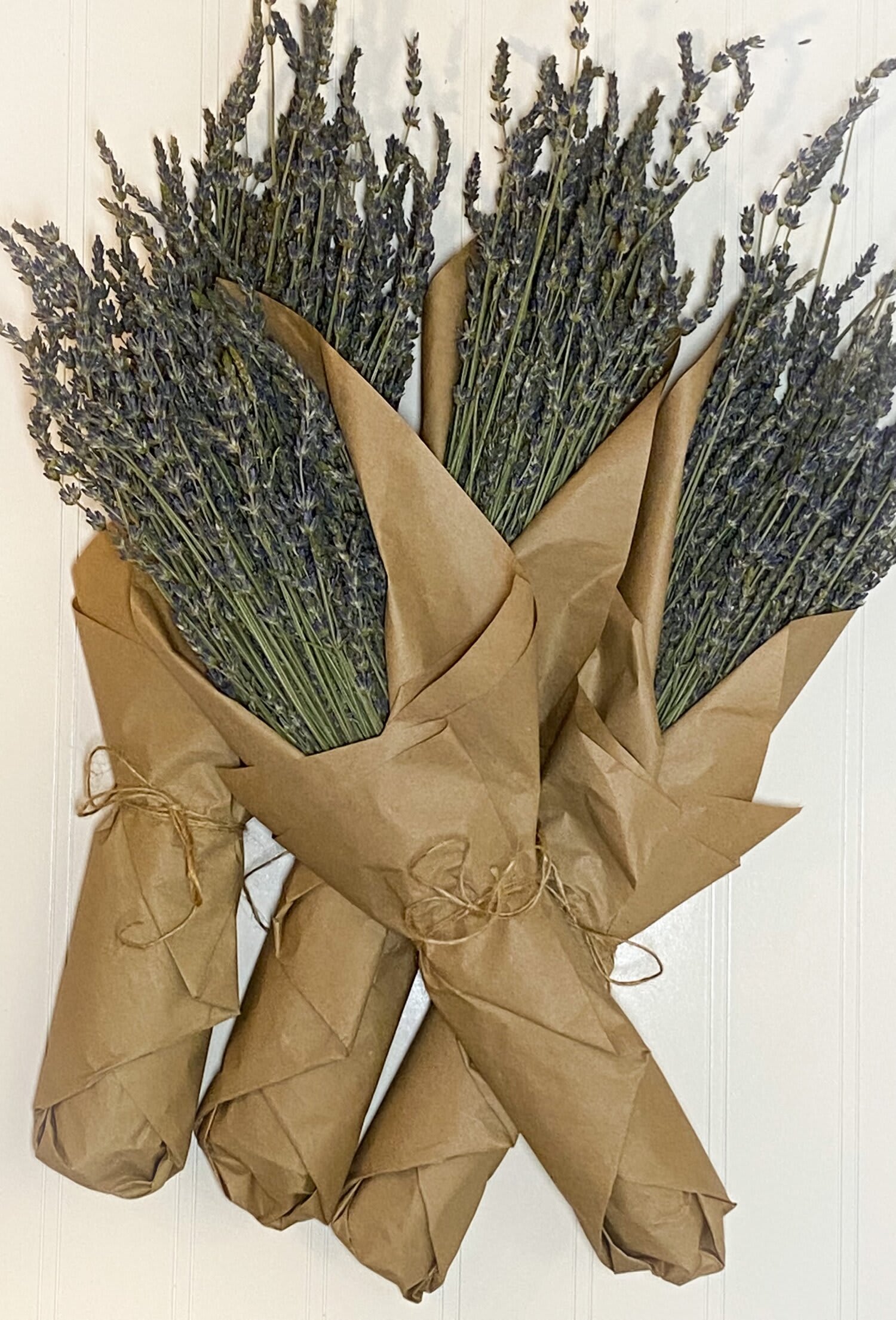 Three wrapped lavender bundles tied with twine