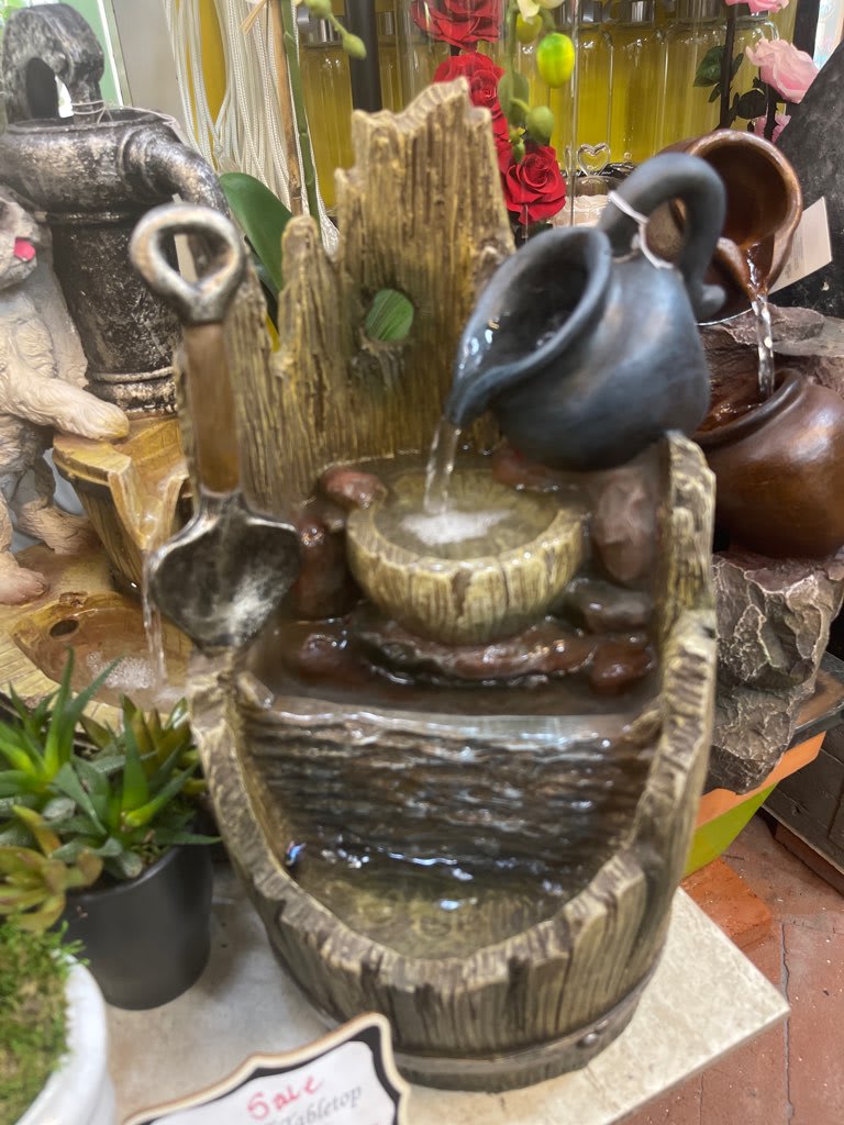 Decorative tabletop water fountain with ceramic pitchers and bowls