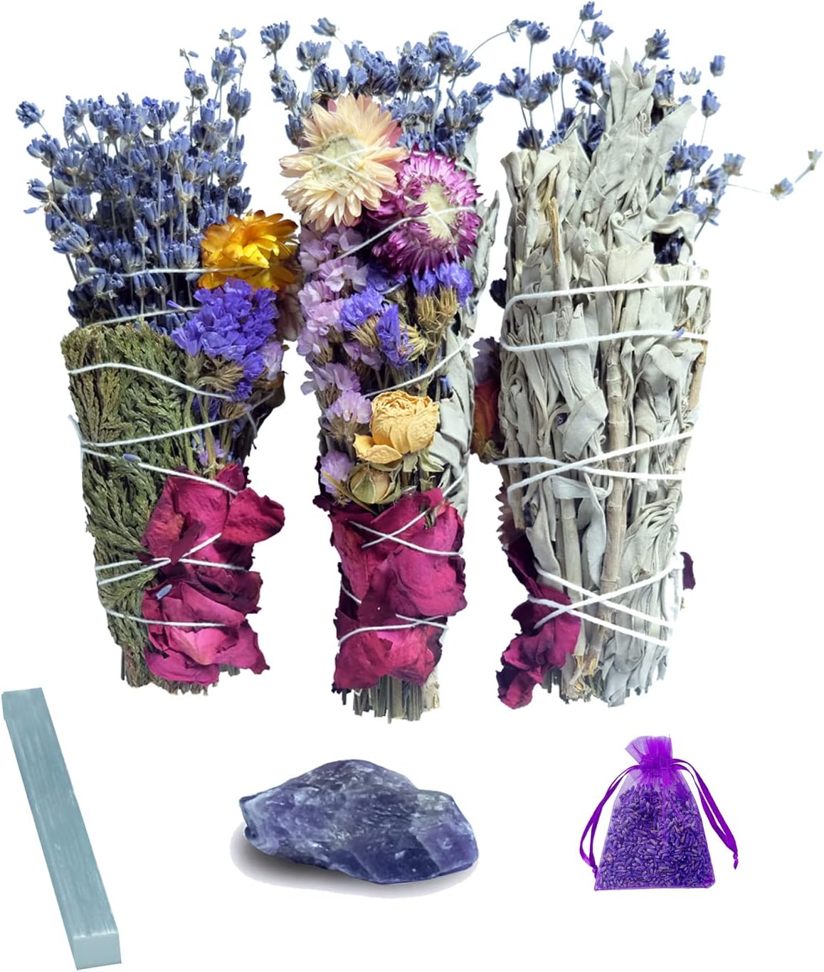 Bundles of dried flowers and herbs with a purple sachet and a blue stone