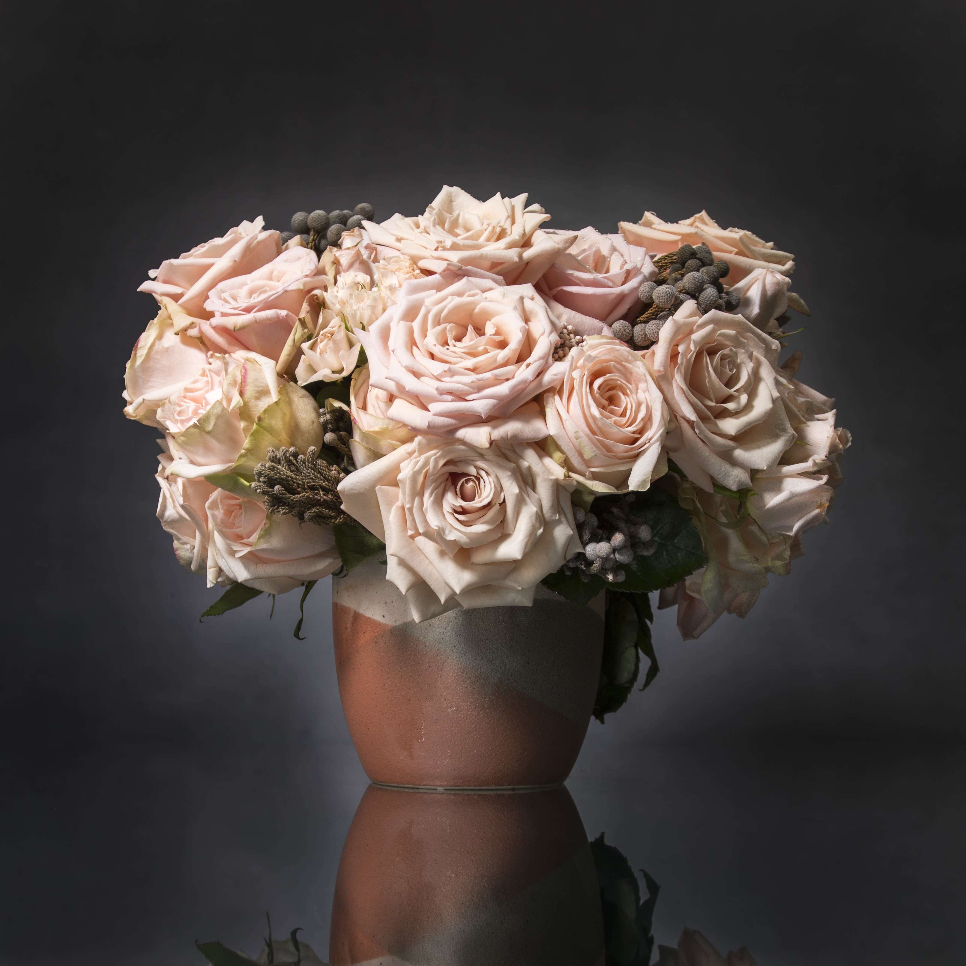 Just Peachy! - Breathtakingly beautiful, these ruffled Peach Garden Roses and spry rosesare divine in a tri-color ceramic vase. It’s tough not to get swept away the moment your eyes meet this vibrant bouquet.   