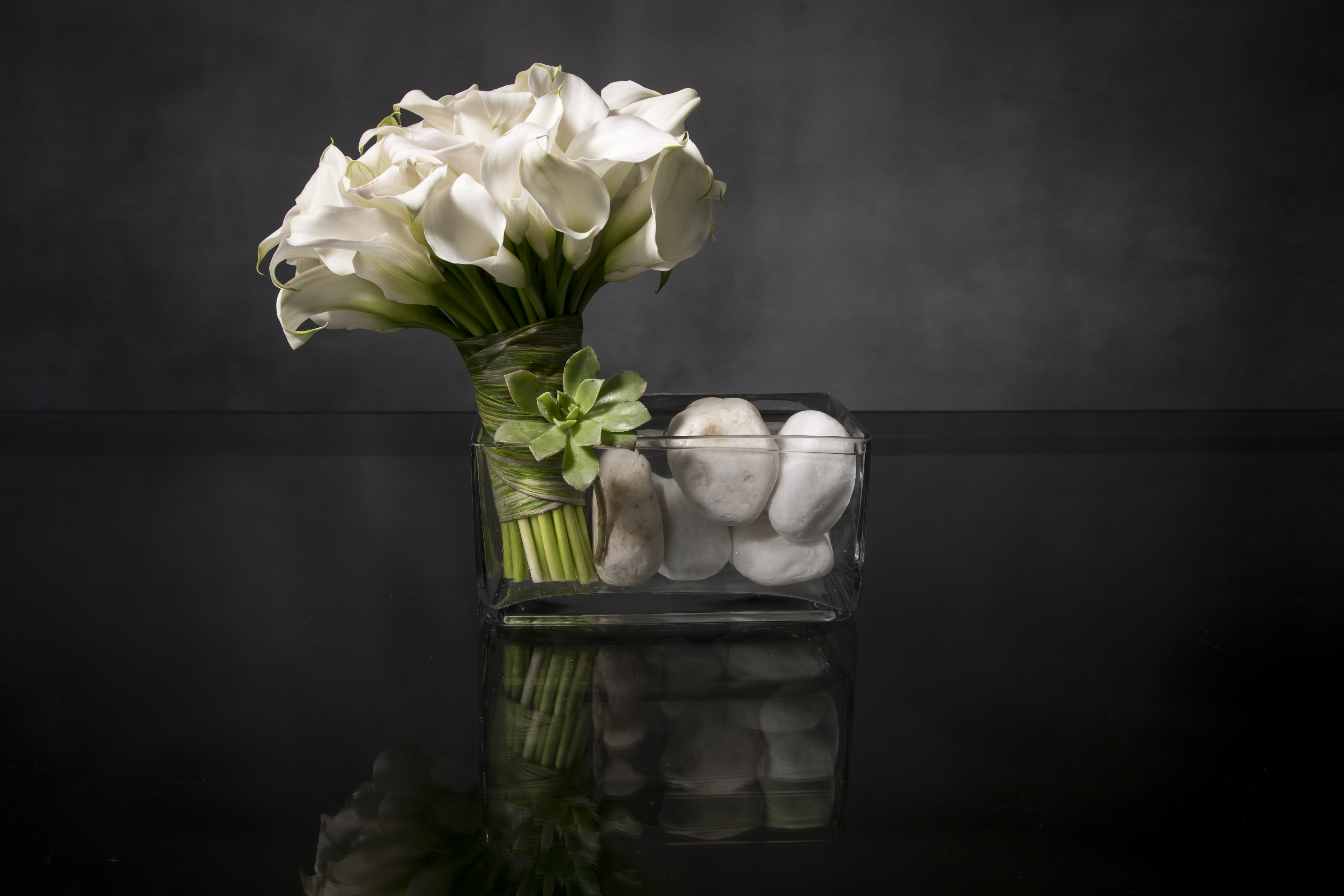 Lady Calla  - This beautiful bouquet will arrive in style! Ready for the runway, as it were. A delightful combination of White Callas with a succulent presented in a stylish glass vase, it's simply beautiful.  Standard as shown   