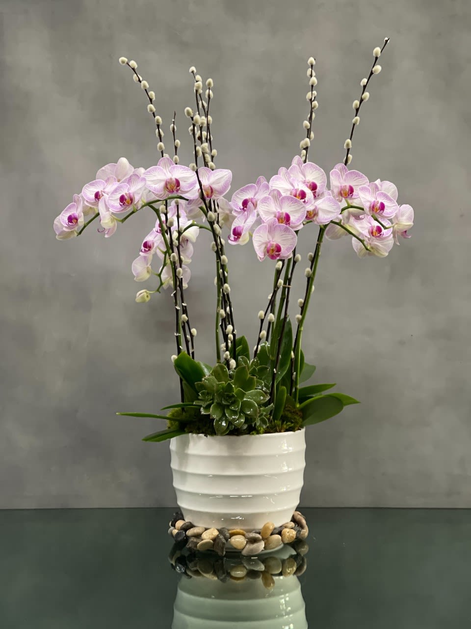 Purple Garden  - Escape into your very own a tranquil Zen garden with this serenely lovely arrangement of 6 medium white with purple Phalaenopsis Orchids with stems of pussy willows potted in a sleek, pebbles embellished vase.  It's an elegant gift of peace for any home or office. 30 inches tall  