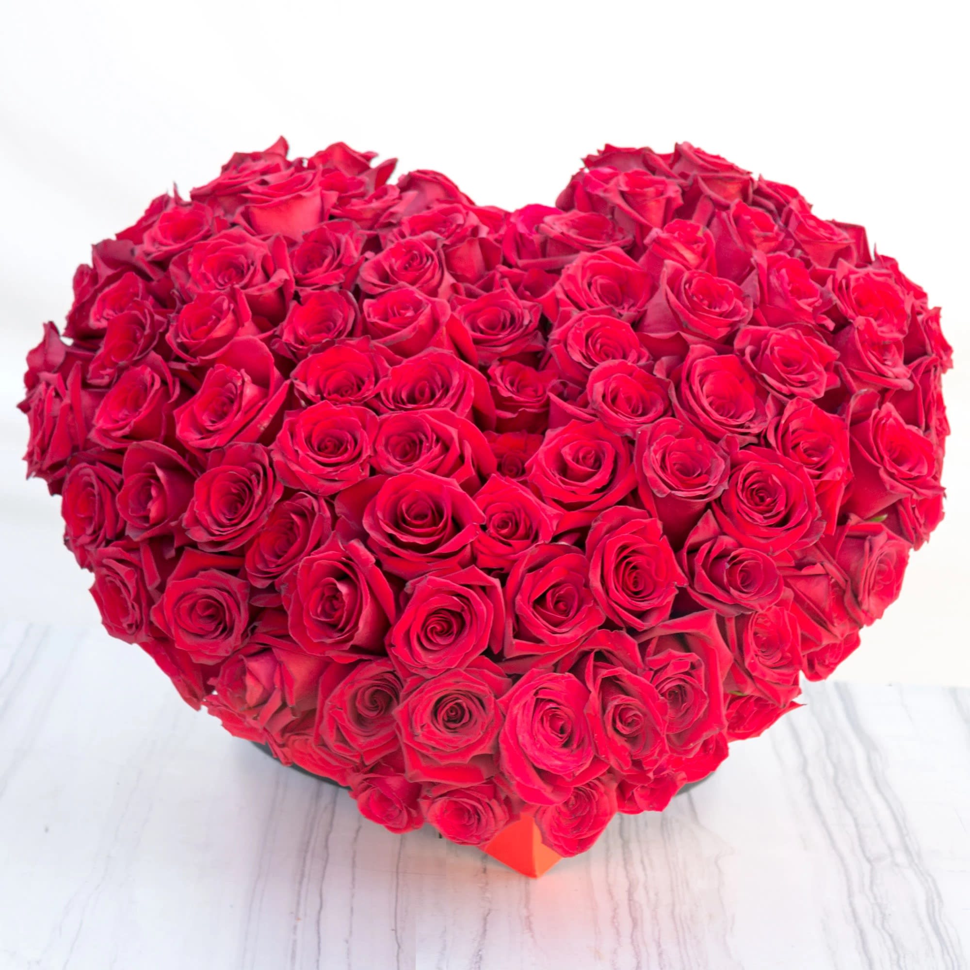 Free Your Heart - Truly breathtaking and magnificent and over the top! This huge and unforgettable display of love is known to bring tears of joy to the receiver.   Dozen of gorgeous bright Red South American Roses fill this heart-shaped box with sentiments also over the top... Say I LOVE YOU in a BIG WAY!!!!!