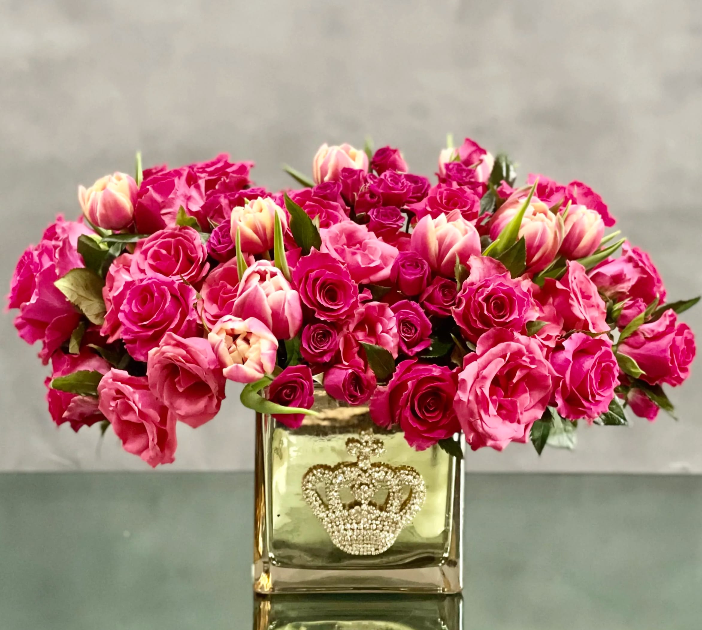 Sweet Mom of Mine - A cluster of pink tulips and roses in a bejeweled crown gold glass vase.