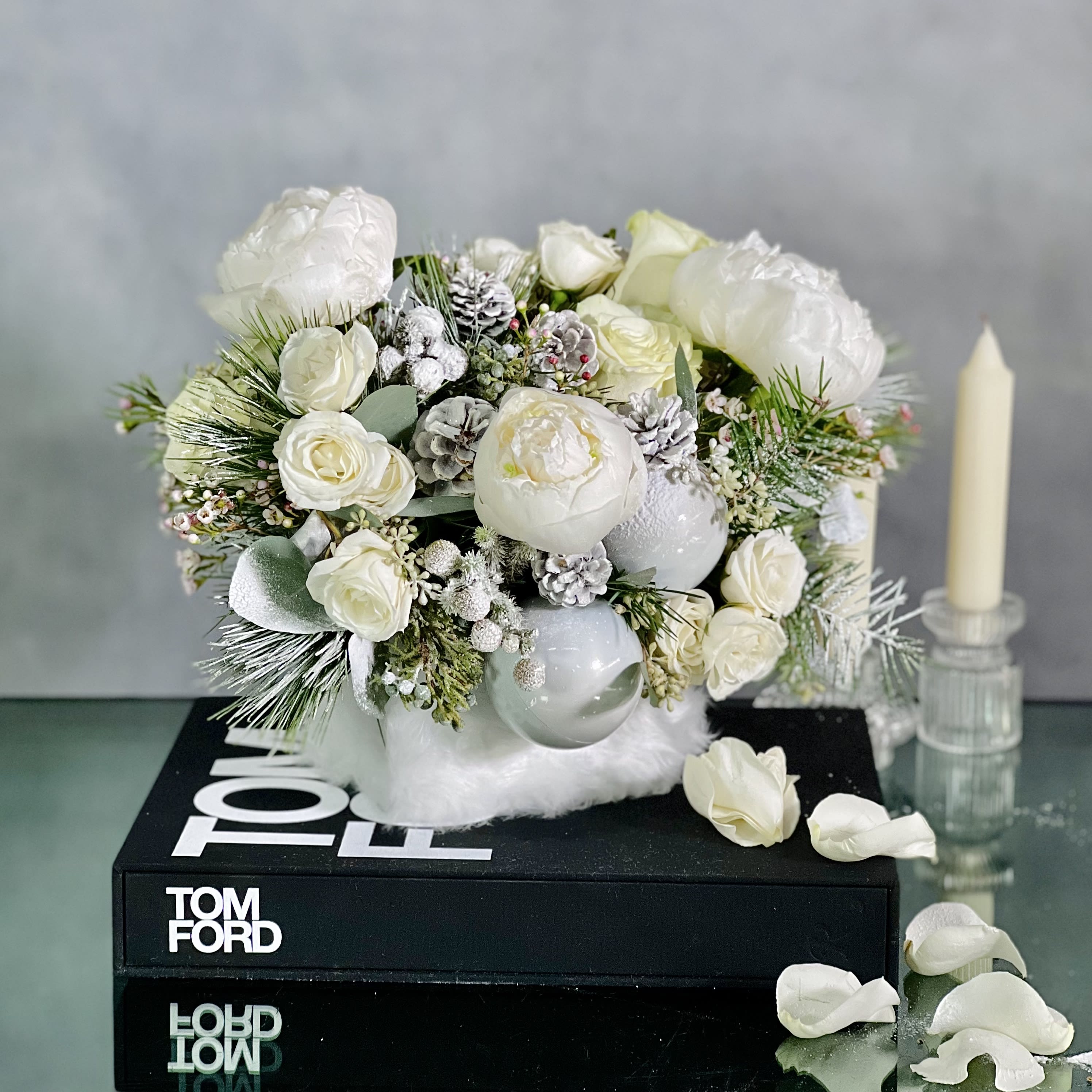 Winter morning - This arrangement will bring a sophisticated look with Peonies, Princess Holiday Greens, Berries and Spray Roses to the holiday spirit that you want to bring to the table. This floral centerpiece is perfect for any dining area, kitchen or coffee table. It includes an array of all white arrangement nested within a Faux Fur Wrapped Container.   Measurement:   18" Wide X 11" Tall in a faux Fur Container 