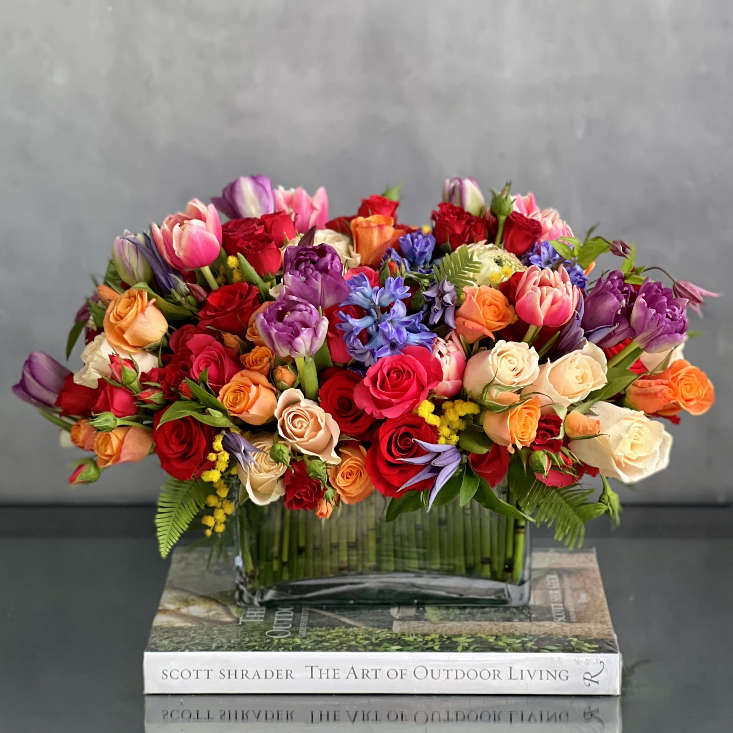 Eruption Of Love  - My Beverly Hills Florist presents our "Eruption Of Love", perfect for Valentine's Day, Just Because, Birthday or I Love You. An arrangement made with Peach &amp; Red Roses. Various colorful spray Roses, seasonal greens &amp; Pink and Purple Tulips. Accented with Hyacinths.  Measurements:  Vase: 8 x 4 Arrangement: 18 x 11