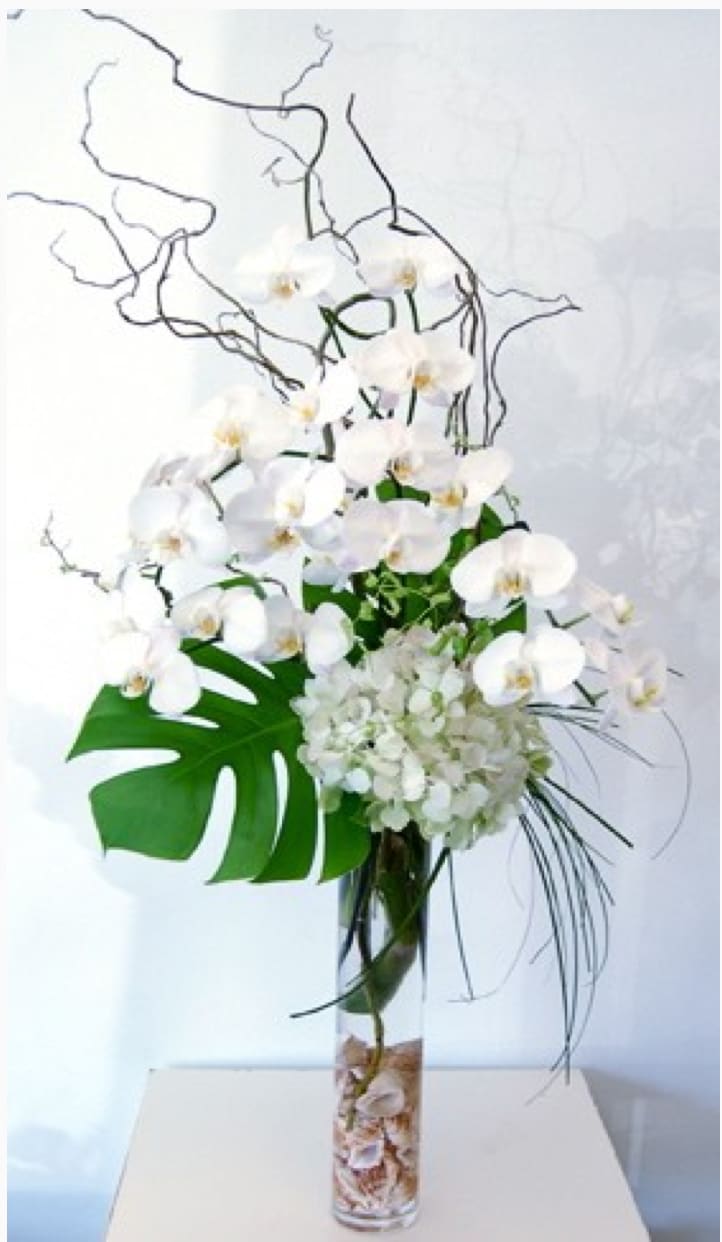 Orchids In The Sky - This arrangement has the dimensions of: a head of 24" and a height of 36". The design features a stunning set of white Orchids placed into a tall vase accompanied with contrasting branches. Brought to you by My Beverly Hills Florist, this wonderful design is a great way to bring some living beauty into your home or another's.