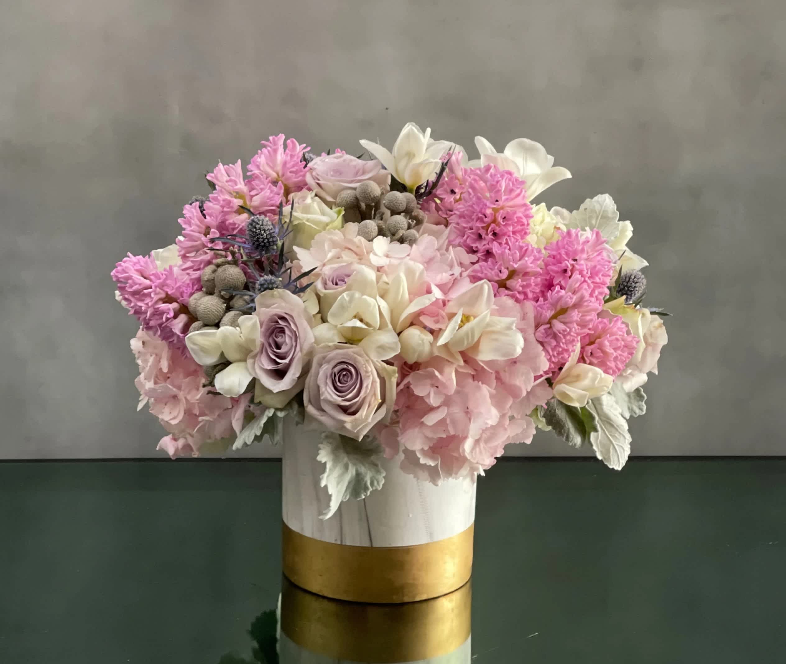 Powder Puff - Pasadena Florist - A full, fluffy, fragrant arrangement filled with lovely pastel hyacinths and  lavender roses. Powder pink Hydrangeas add fullness while accent florals sprinkle in additional colors. This arrangement is perfect for everyday or a special day.