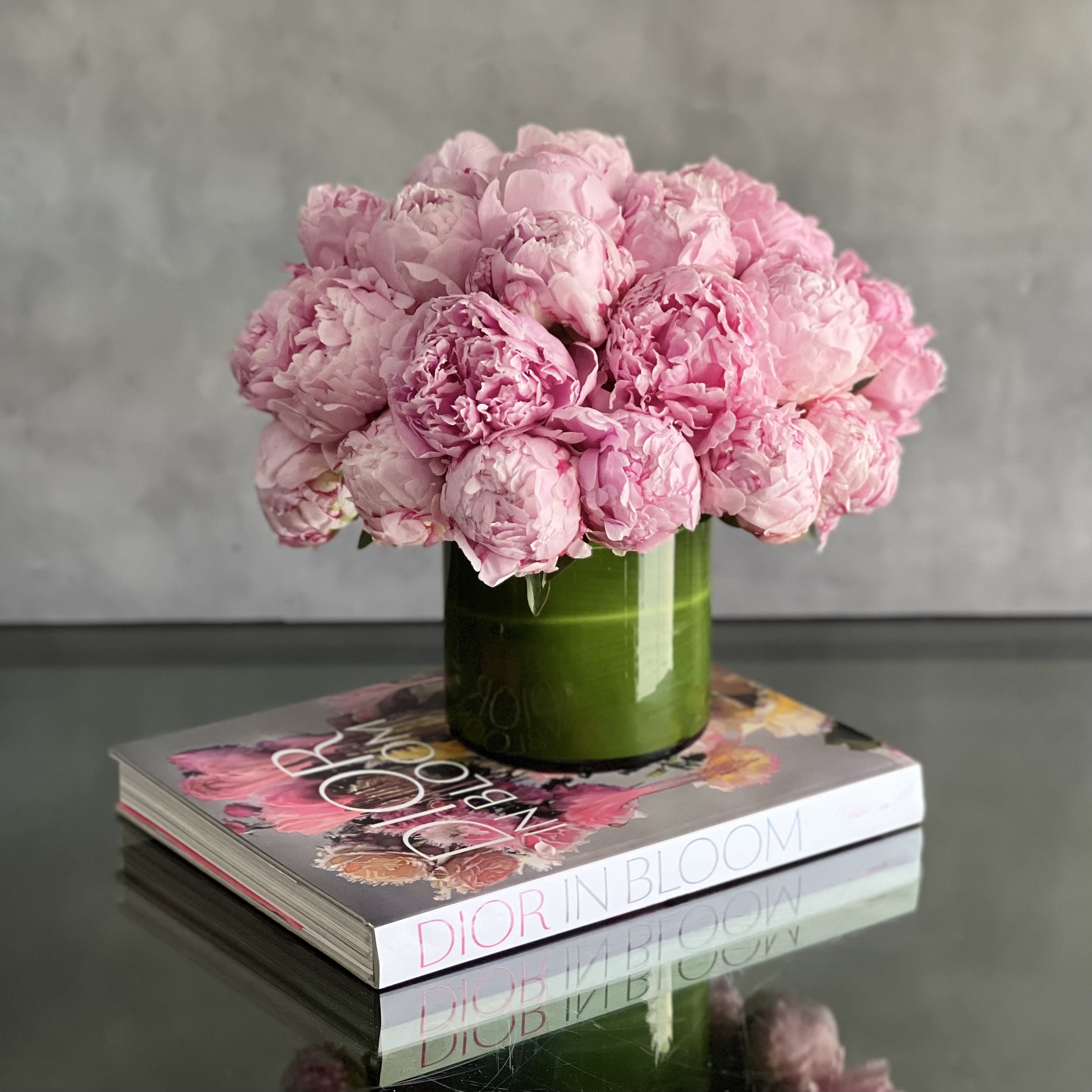 Pink Peony Pave - Pasadena Florist - Imagine for SAME DAY DELIVERY a radiant bouquet of pink peonies, expertly arranged in a pave style to create a lush and opulent display. Each delicate bloom is carefully nestled together, creating a breathtaking harmony of color and texture. The soft, blush petals of the peonies exude a sense of elegance and grace, while their sweet fragrance fills the air with a subtle, yet enchanting aroma. These stunning blooms are presented in a leaf-lined glass vase, adding a touch of contemporary chic to the arrangement. The transparent vessel showcases the beauty of the peonies, allowing their natural charm to shine through while providing a modern backdrop for their splendor.  Perfect for someone with discerning taste, this arrangement exudes sophistication and refinement. Whether it's to celebrate a special occasion or simply to brighten someone's day, this bouquet is sure to make a memorable impression. And with same-day delivery, you can rest assured that your thoughtful gift will arrive promptly, ready to delight its recipient with its timeless beauty.