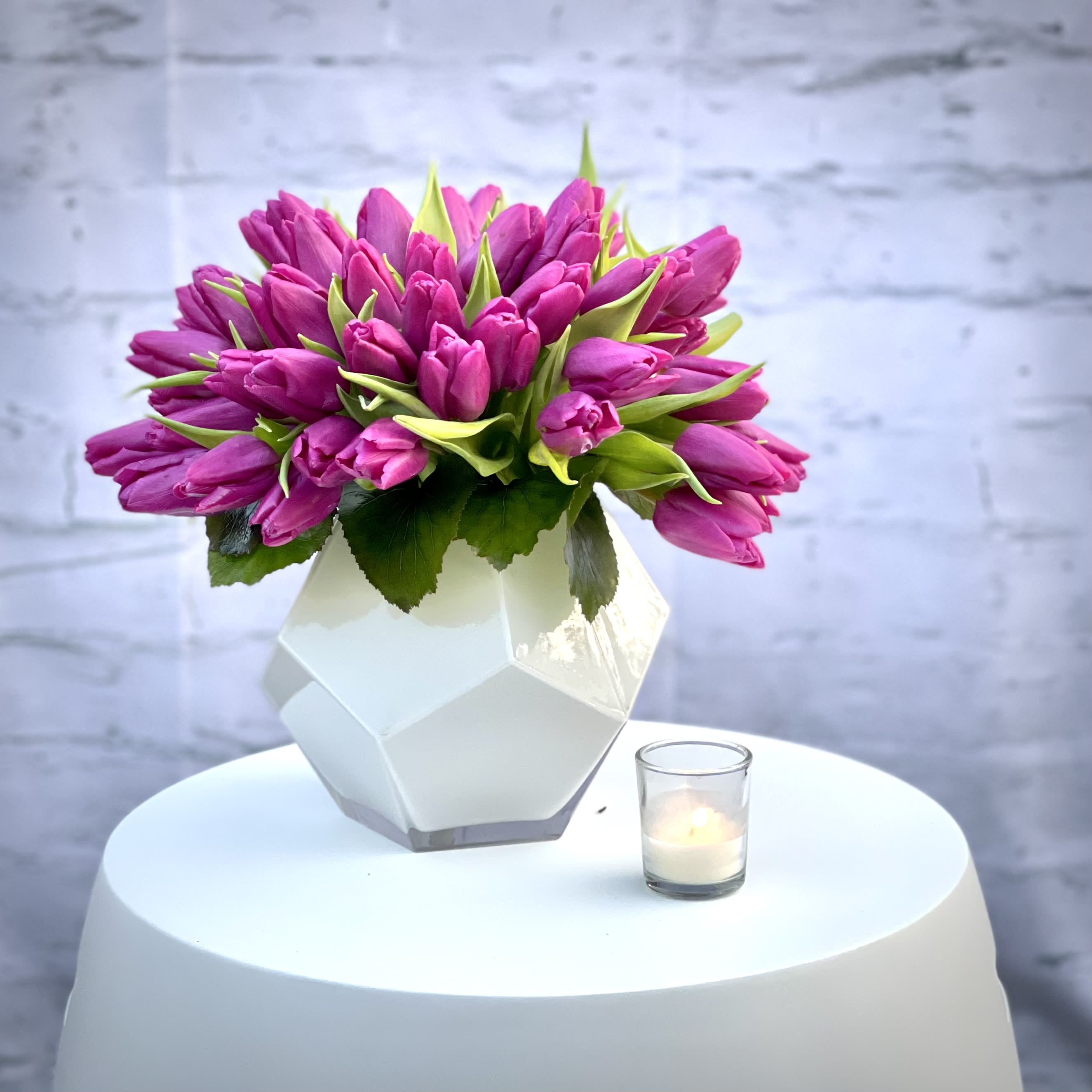 Pink Lady - 50 beautiful pink tulips in a glass geometric glass vase.