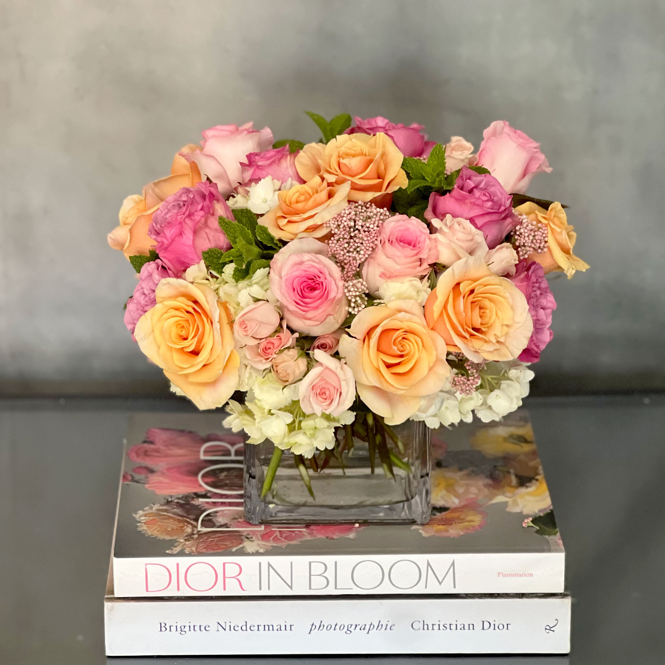Morning Melody - Manhattan Beach - Delicate and angelic... this beautiful mix of roses, Imported Ecuadorian Roses, Dutch Spray Roses and Rice Flowers in a Glass vase brings charm and beauty in any room. Its perfect for any gift-giving occasion or celebration.  Measurement:  11" Round in a 6 X 6 