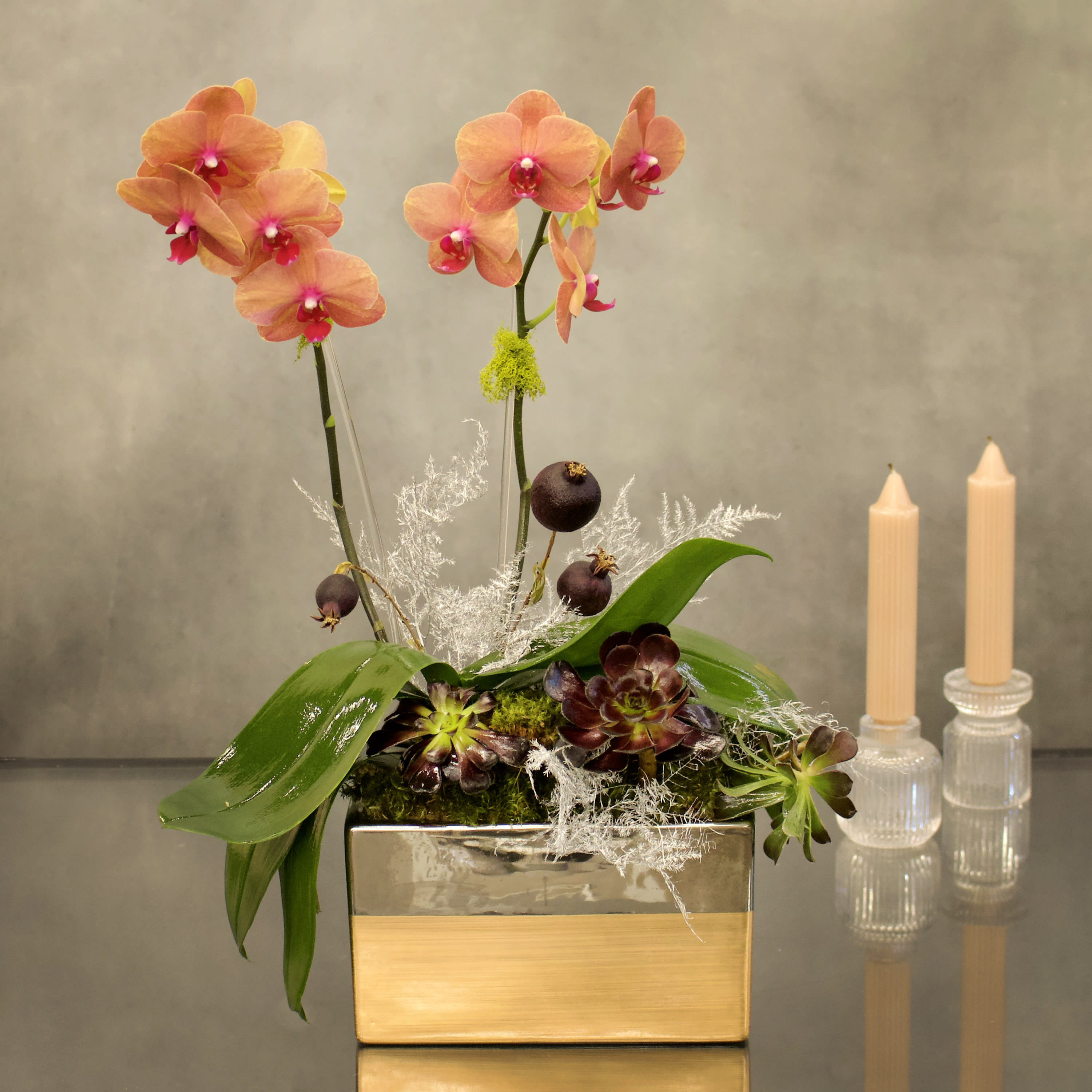 Mini Fall Peach Orchids - Welcome the fall season with this mini peach orchids nested in the a copper silver vase with succulents